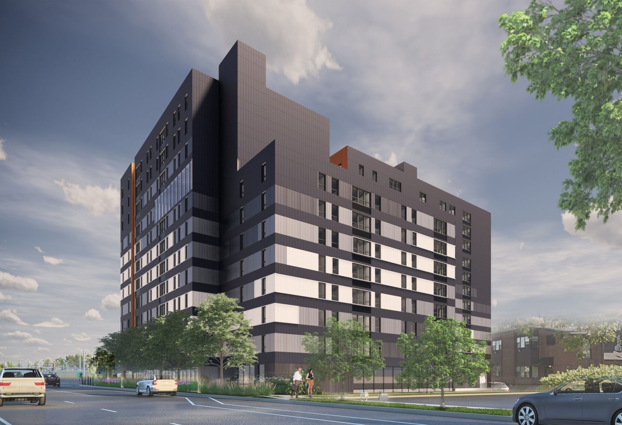 A modern multi-story apartment building with a dark facade and large windows, exuding a distinctive identity against the backdrop of a partly cloudy sky.