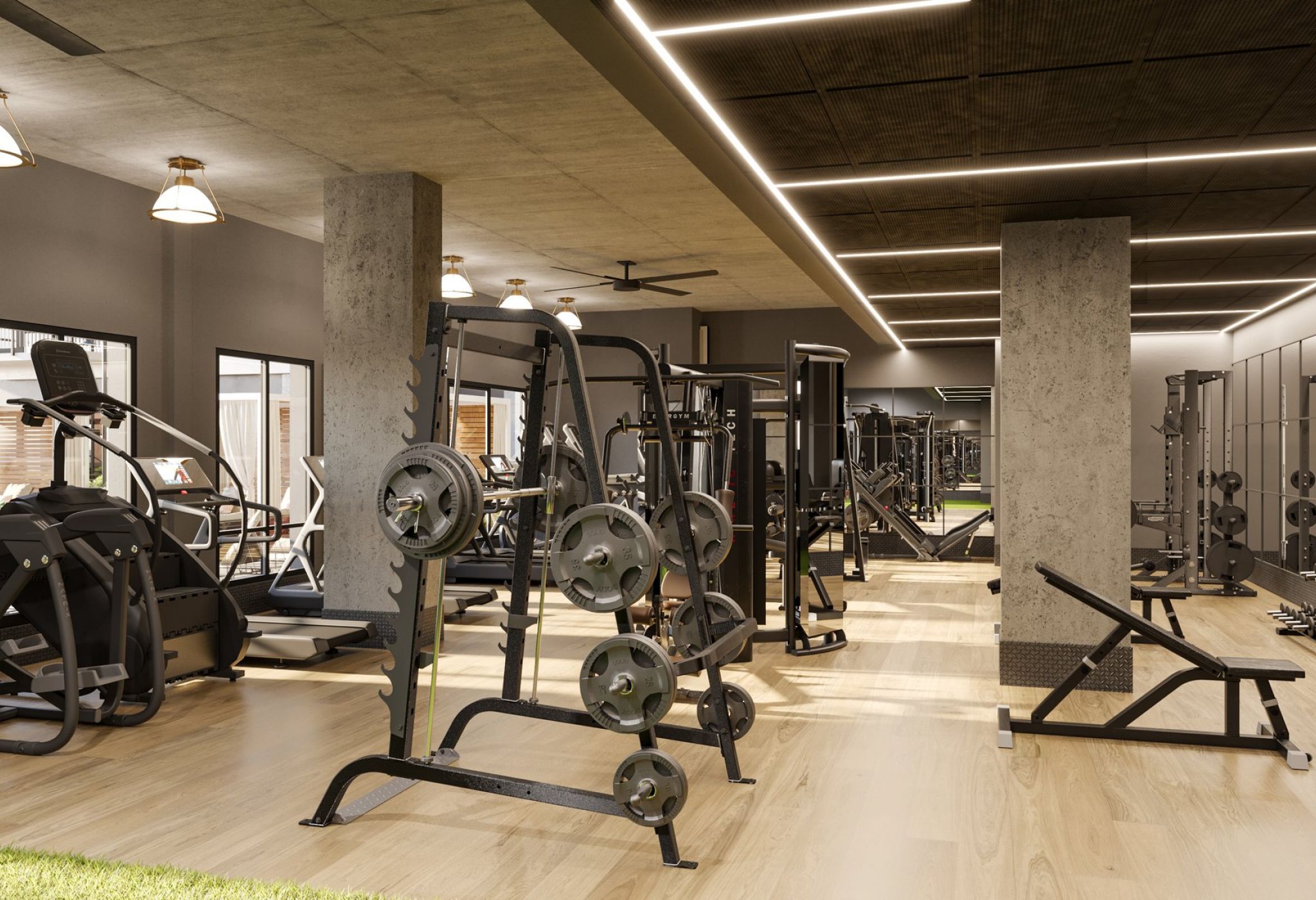 A modern gym in Nashville featuring various fitness equipment including treadmills, weightlifting machines, and free weights. The space boasts large mirrors, concrete pillars, and a sleek, contemporary design with wooden flooring and ample lighting. It's the perfect spot for locals to stay fit.