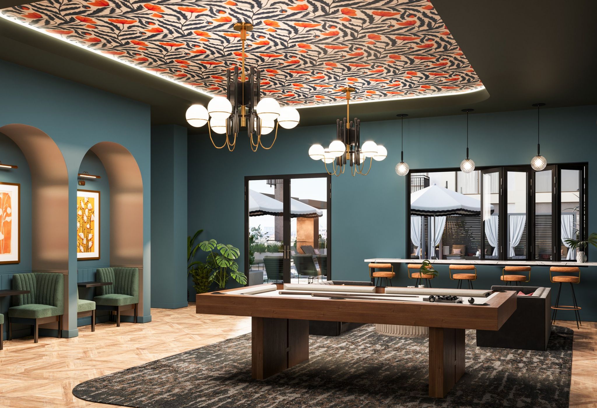 A modern recreation room with blue-green walls, a patterned ceiling, and a central billiards table. The room features chandeliers, bar stools facing large windows, and cozy seating areas with archways